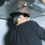 A home inspector checking a vent