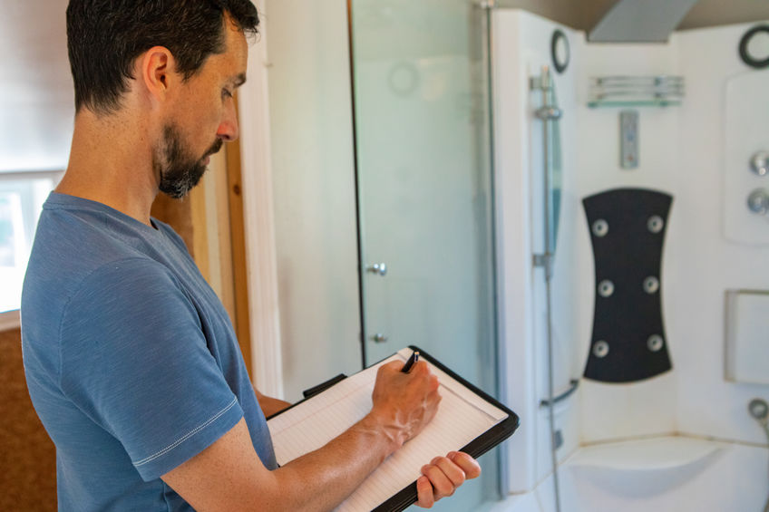 Mold inspector looking at bathroom