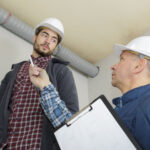 Home inspector looking at plumbing pipes